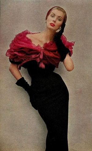 1952suzy parker in givenchy's deep red roses. a bolero of a thousand chiffon petals piled above a strip of black wool. darker than the roses, and velvet