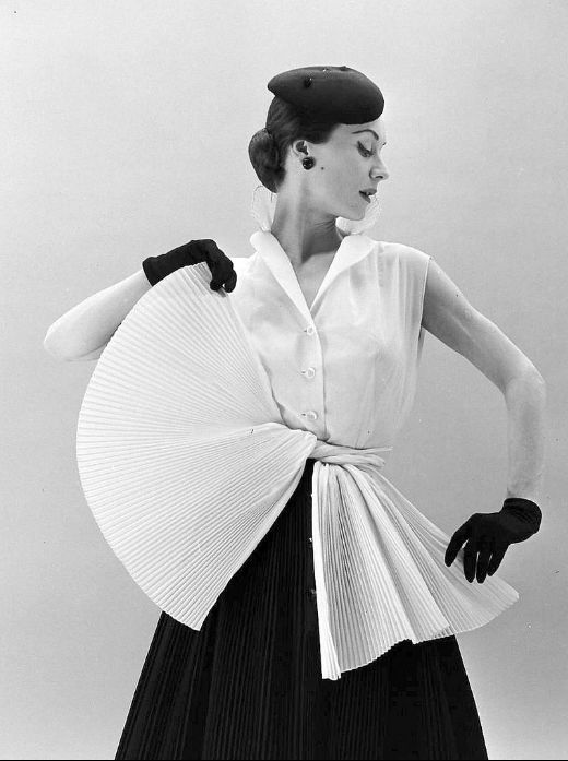 1952Gigi is wearing sleeveless blouse with skirt and sash made of tiny accordian pleats by Givenchy, photo by Nat Farbman 