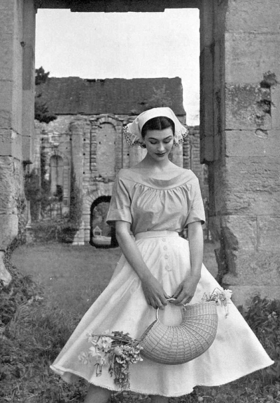 Anne Gunning in sky blue blouse with boat-neck and white starched skirt with fluted hem, by Givenchy, photo by Pottier, 1952