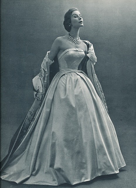Hubert de Givenchy designed this stunning ballgown in 1953. White silk satin strapless gown is set off with an embroidered long stole lined in pink.