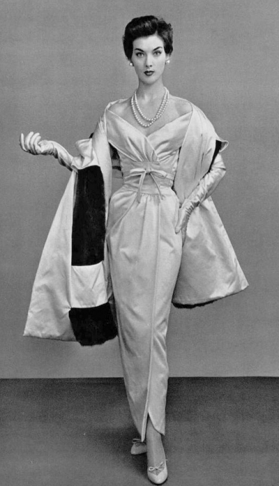 1954 Rose Marie in white satin evening gown, bodice crosses into v-neckline, the skirt is narrow and folds over , the long stole is lined in mink, by Givenchy