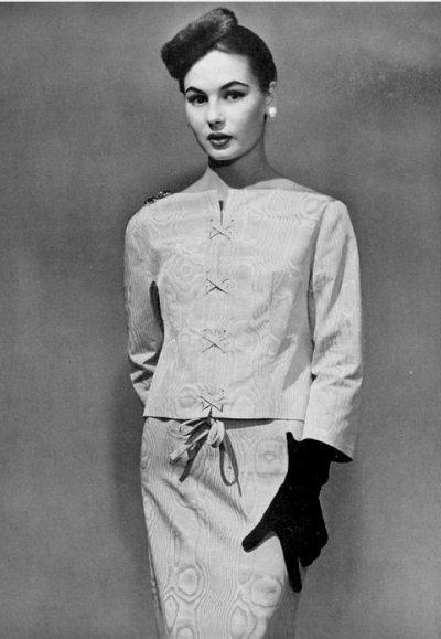 Model in elegant moiré two-piece criss-cross laced and tied in front, by Givenchy, photo by Georges Saad, 1954