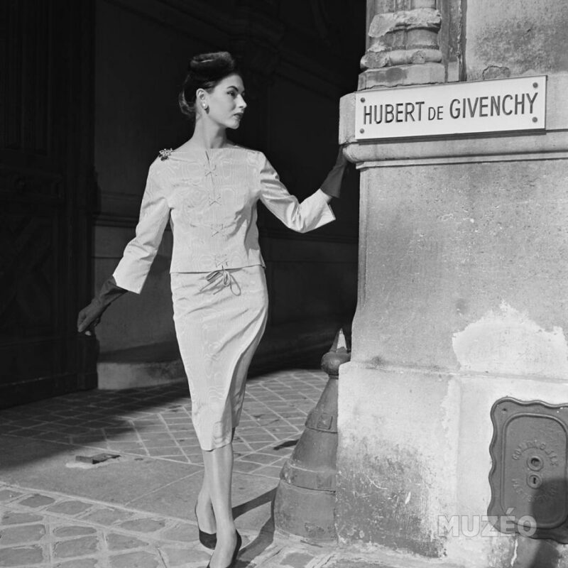 1954 Model in elegant white moiré two-piece criss-cross laced and tied in front, by Givenchy