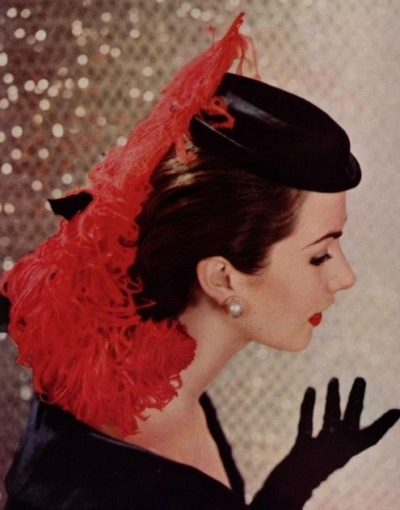Model in Empress Eugenie-inspired satin hat adorned with ostrich plume that dips down in the back by Givenchy, photo by Pottier, 1954
